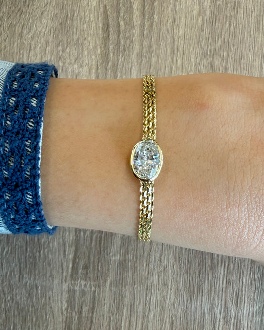 2 ct bezel oval on 3 row yellow gold bracelet
