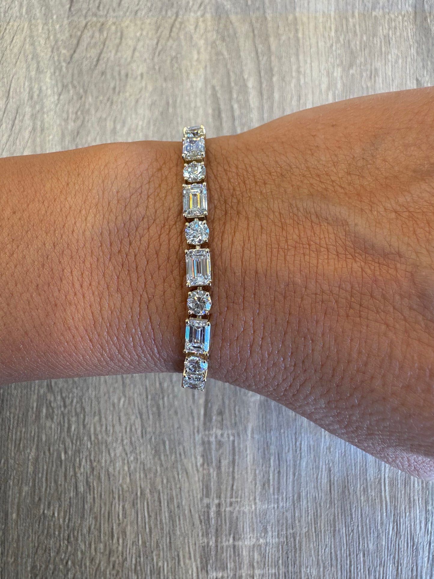 17.38 cttw yellow gold emerald, and round tennis bracelet
