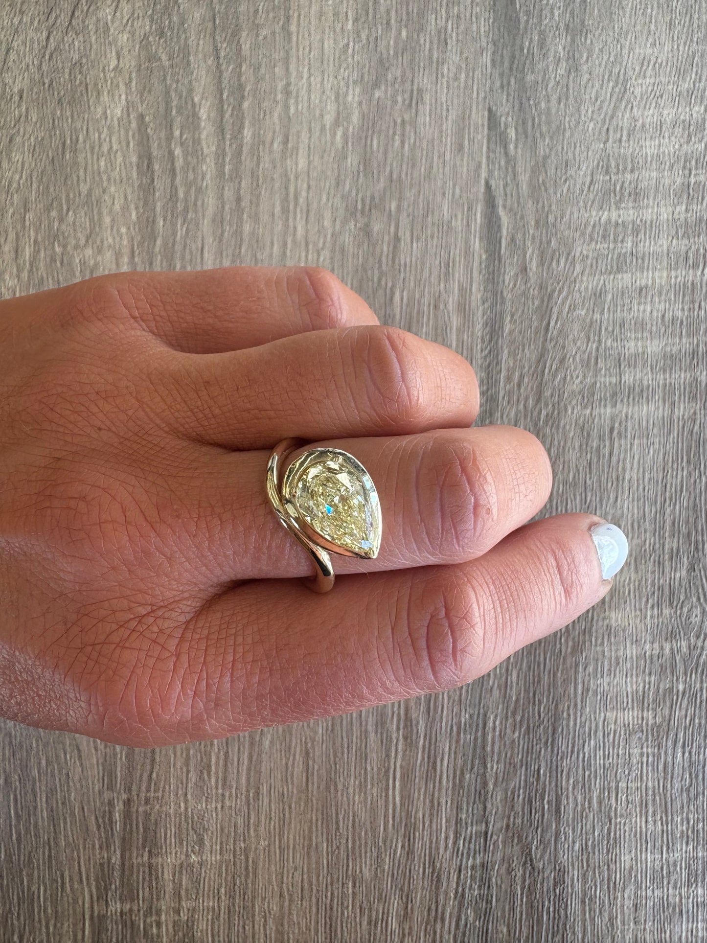 3.4 ct yellow pear bezel diamond on wave band