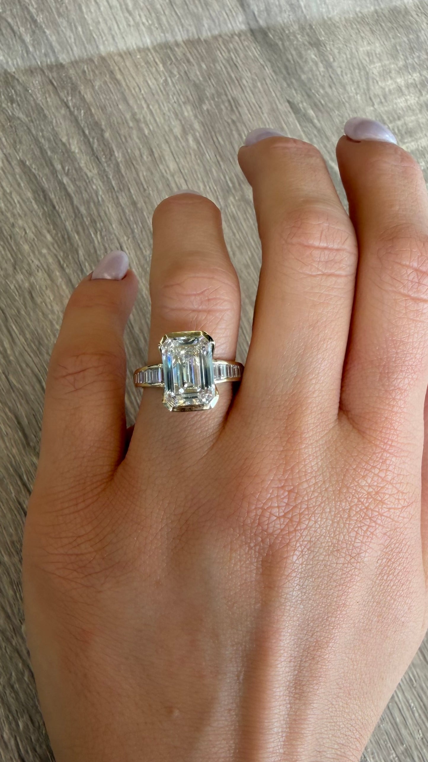 5.64 cttw half bezel emerald on yellow gold band with baguettes