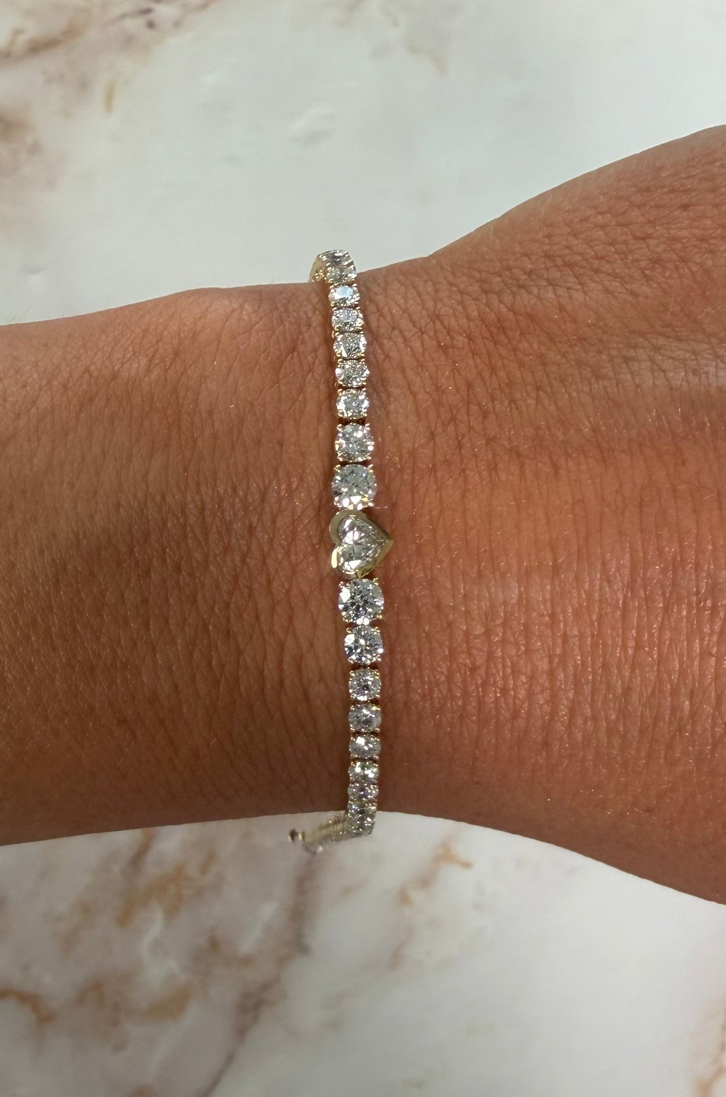 5.5 cttw yellow gold graduated tennis bracelet with bezel heart center